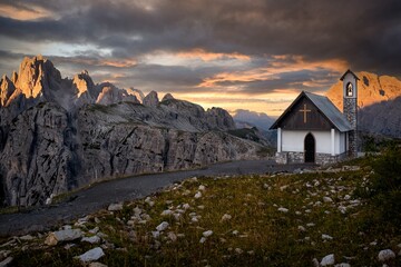 Little chapel in mountain at sunrise sunset. Tre chime di Lavaredo in Dolomites. Tyrol. Italy