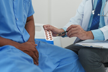 A male doctor is inquiring about the testicular cancer test report of a male patient for diagnosis...