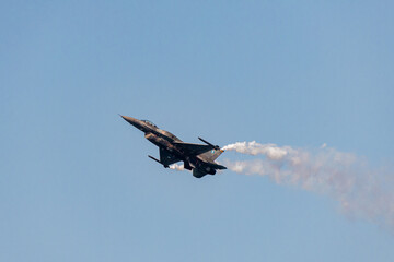 Fighter jet flying in the blue clear sky demonstrating skills_1