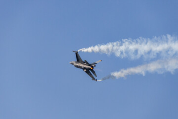 Fighter jet flying in the blue clear sky demonstrating skills_8