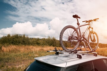 Outdoor Adventure Awaits. Family Car with Bicycles Mounted on Roof Rack. A vehicle with top mounted...