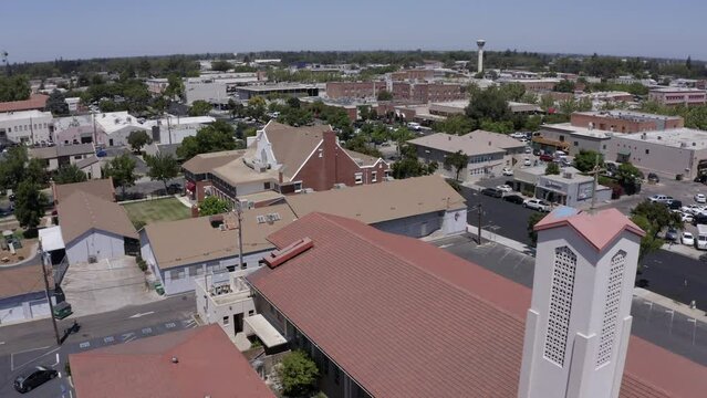 Lodi, California, USA - July 16, 2021: Sunlight shines on the historic downtown buildings and churches of Lodi.