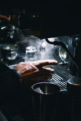  Man's hand working on a coffee machine