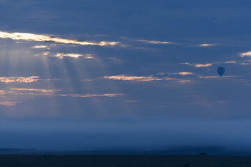 Savanna landscape africa, sunrise and hot air balloon