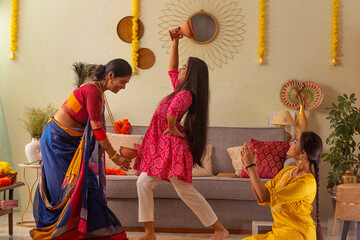 Bengali family practising dhunuchi dance at home on the occasion Durga Puja