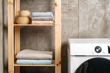 Fototapeta na wymiar Clean folded towels on shelf in a bathroom