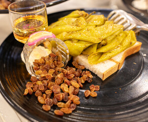 Roasted vegetables and raisins in a plate in a restaurant