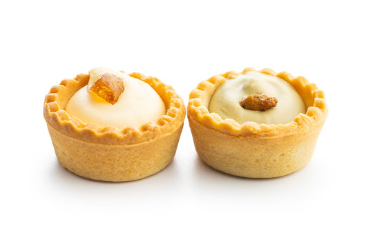 Sweet tarlets. Tasty mini tarts. Mini pie with cream isolated on white background.