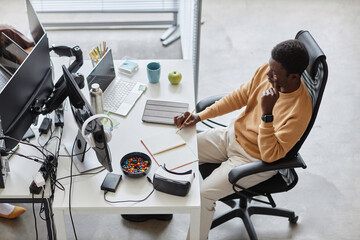 High angle view of African American developer planning work at his workplace