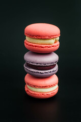 multi-colored macaroons on a black background