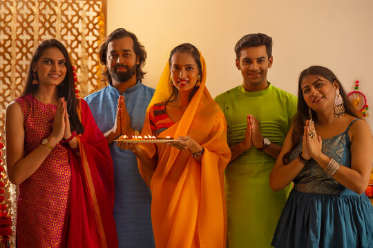 Friends in traditional outfit greeting together on the occasion of Diwali