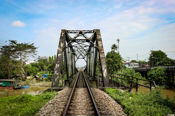 Vintage rusty old railway bridge over the river. - obrazy, fototapety, plakaty