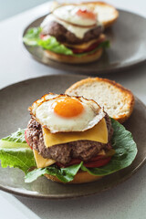 Delectable homemade cheeseburger garnished with a perfectly fried sunny-side-up egg