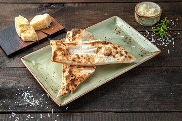 Lavash with grilled cheese. Menu for a restaurant. Beautiful composition on wooden boards.