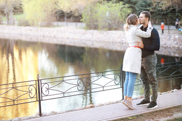 A man and a girl in love on a first date in an autumn city park.