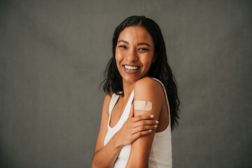 Lovely close up of multiethnic female touching her sore arm  - obrazy, fototapety, plakaty
