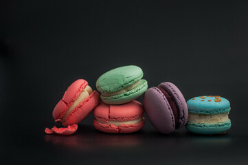 crushed multi-colored macaroons on a black background