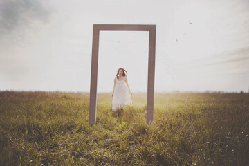 woman running towards a surreal door in the middle of nature, abstract concept