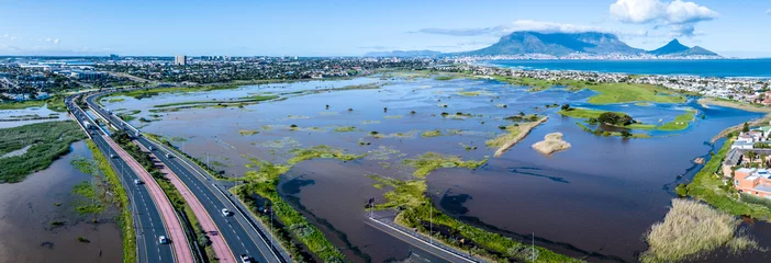 Photo sur Plexiglas Montagne de la Table Panoramic view of storm flooding in Cape Town, South Africa, the Diep River breaking its banks after an exceptionally deep cut-off low pressure system hit the Western Cape. High level view. 