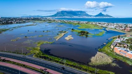 Photo sur Plexiglas Montagne de la Table Widespread storm flooding in Cape Town, South Africa, after an exceptionally strong winter storm. Drone view, Table Mountain in background. 