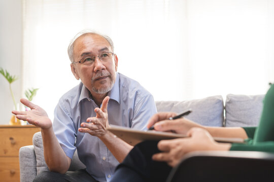 Psychology, Depression People. Elderly Asian Patient Man, Male Consult With Psychologist, Psychiatrist. Older Doctor Woman Consulting, Counseling Mental Health At Clinic. Encouraging, Therapy.