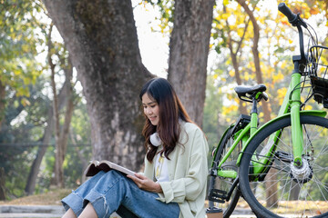 Woman reading book at prk for relaxation.