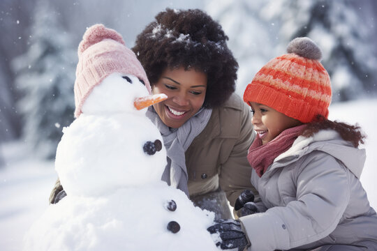 African family building snowman at the park in winter
