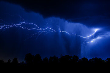 lightning in the night with blue sky