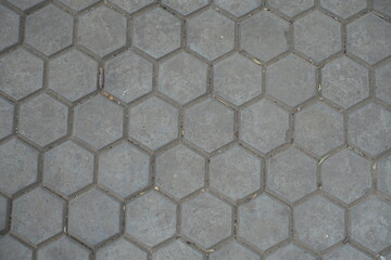 Backdrop - gray concrete pavement with honeycomb geometric pattern