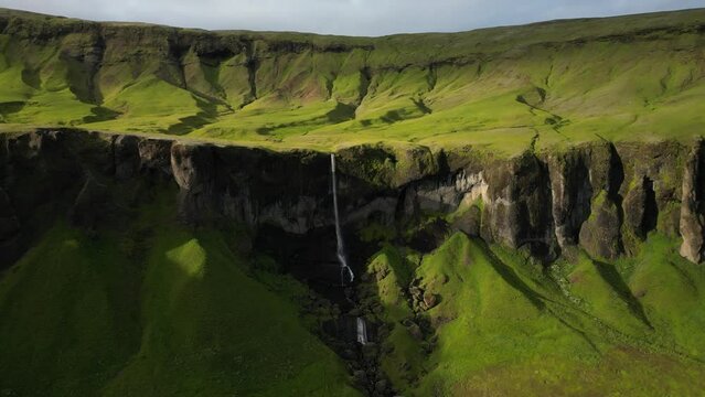 Stunning landmark covered in sunlight at dusk, river turning into a waterfall