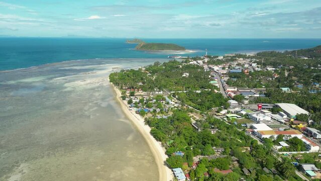 Koh Phangan Island aerial shot with Thongsala Pier, ko tae nai island, and Koh Tau Island, drone shot orbital