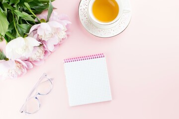 Peony Flowers, Tea, Eyeglasses and Blank Notepad on Pink Background