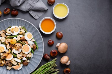 Fototapeta na wymiar Salad with Chestnuts, Mushroom, Asparagus and Eggs on Grey Stone Background, Top View, Autumn Dish, Flat Lay, Copy Space
