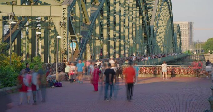  Crowd of tourist people walk on Hohenzollern bridge in Cologne, Germany. Timelapse