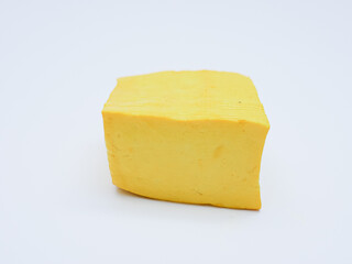 raw yellow tofu isolated on white