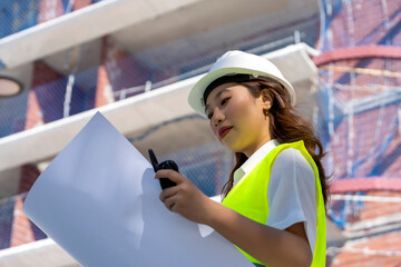 female architect looking at construction plans