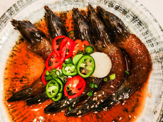 Korean Salted Shrimp is on a plate ready to eat. Salted shrimp are shrimp that are preserved by adding salt and vinegar, giving them a unique salty and tangy flavor.