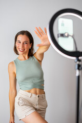 influencer girl. happy girl recording a video for social networks. He is waving at the camera. Copy space