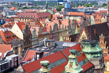 Naklejka premium Bright historical houses on the Market square at Old Town in Wroclaw, Poland. Top view from the Bridge of Penitents of Cathedral of St. Mary Magdalene 
