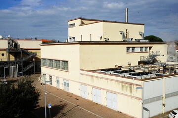 Fototapeta na wymiar Factory seen from the ancient walls of Pisa, Tuscany, Italy