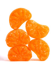 mixed fruit sugar syrup candies on white background, orange candies 