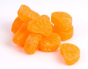 mixed fruit sugar syrup candies on white background, orange candies 