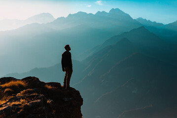 A man looking over the mountains from the edge of a cliff.
Peace and tranquility. - 652713100