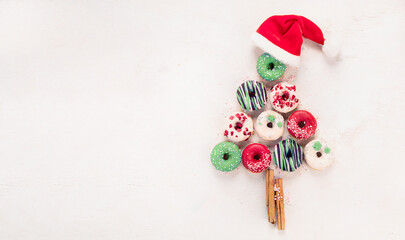 Christmas tree made of sweet donuts. Top view, flat lay on light background