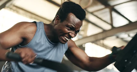 Fotobehang Fitness Black man, fitness and cycling at gym in cardio workout, exercise or intense training on machine. African male person on bicycle equipment in sweat or running for muscle, endurance or stamina at club