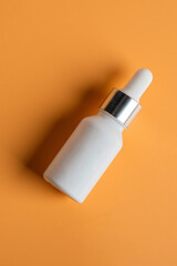 Cosmetic product in tube, bottle, lotion or serum on cream background. 