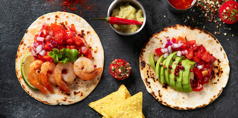 Tacos with salsa, vegetables and avocado on black background