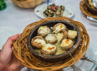 Baked mushrooms with cheese on a table in restaurant in Georgia