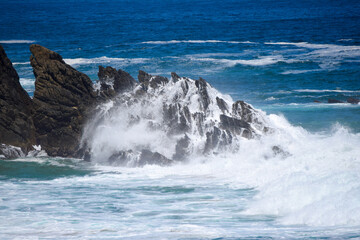 Waves crashing over a rocky shoreline