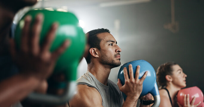Gym, group fitness and kettlebell squat exercise for power, sports challenge and muscle. Serious asian man, bodybuilder and heavy weights for training in health club, workout class and strong friends